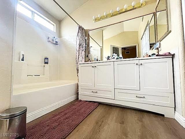 4314 Flaming Ridge Trl, Las Vegas, NV 89147 - bathroom with wood finished floors, shower / bath combo with shower curtain, and double vanity