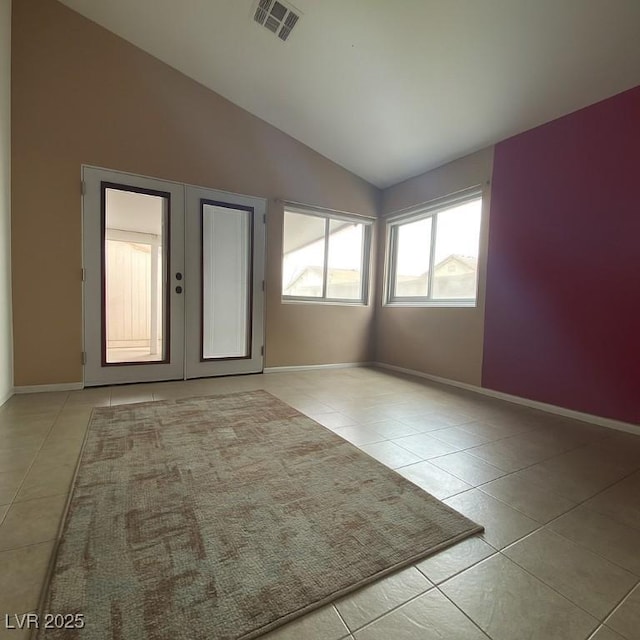 4314 Flaming Ridge Trl, Las Vegas, NV 89147 - empty room with light tile patterned floors and vaulted ceiling