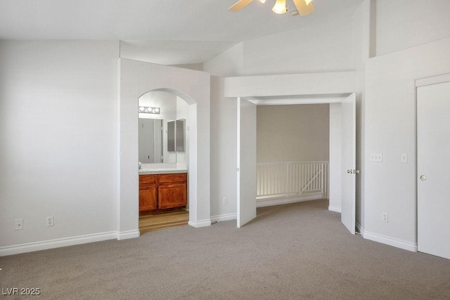 901 Nevada Sky St, Las Vegas, NV 89128 - unfurnished bedroom with arched walkways, light colored carpet, ensuite bath, and ceiling fan