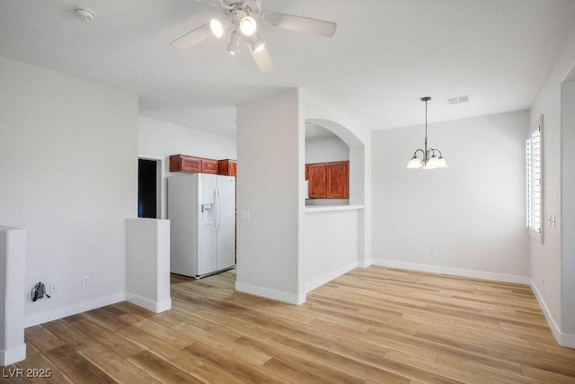 901 Nevada Sky St, Las Vegas, NV 89128 - empty room with a smoke detector, a ceiling fan, light wood-type flooring, a chandelier, and arched walkways