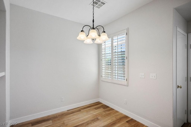 901 Nevada Sky St, Las Vegas, NV 89128 - empty room featuring light wood-style flooring and a chandelier