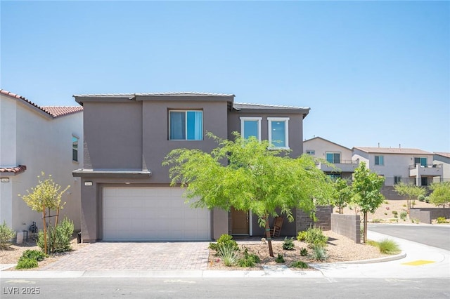 9451 Lunar Ray St, Las Vegas, NV 89143 - view of front of house with stucco siding, an attached garage, a tiled roof, and driveway