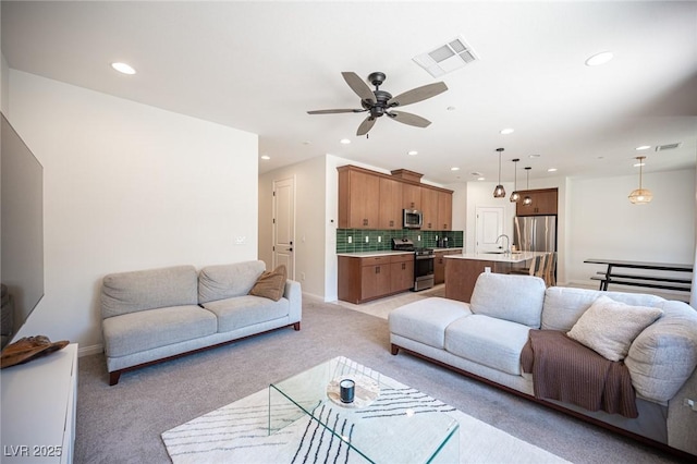 9451 Lunar Ray St, Las Vegas, NV 89143 - living area with light carpet, recessed lighting, and a ceiling fan