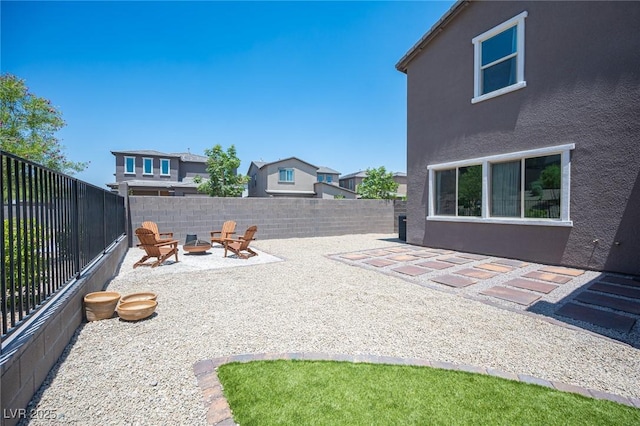 9451 Lunar Ray St, Las Vegas, NV 89143 - fenced backyard with a fire pit and a patio area