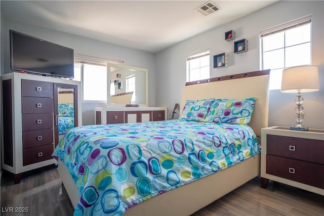 4945 Volcanic Rock Ln, Las Vegas, NV 89122 - bedroom with wood finished floors and multiple windows