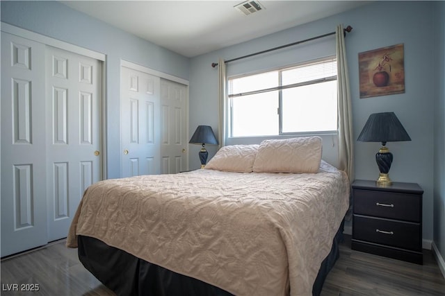 4945 Volcanic Rock Ln, Las Vegas, NV 89122 - bedroom featuring two closets and wood finished floors