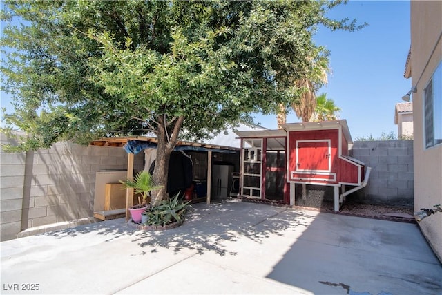 4945 Volcanic Rock Ln, Las Vegas, NV 89122 - fenced backyard with exterior structure, an outbuilding, and a patio area