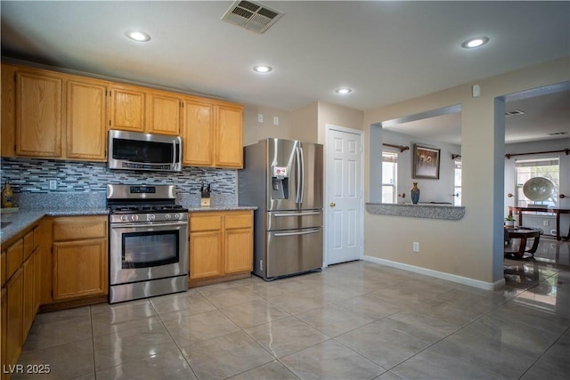 4945 Volcanic Rock Ln, Las Vegas, NV 89122 - kitchen featuring stainless steel appliances, tasteful backsplash, recessed lighting, and light tile patterned flooring
