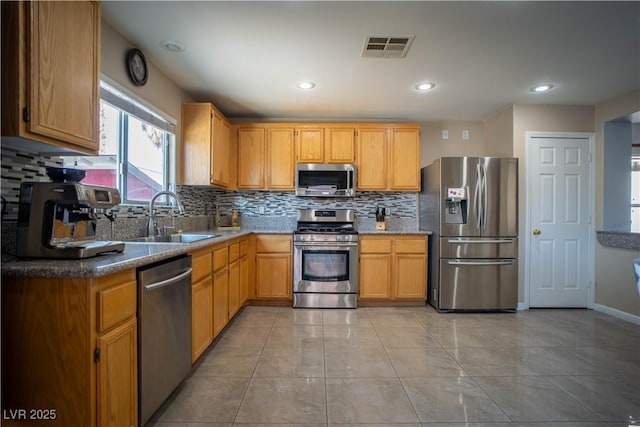 4945 Volcanic Rock Ln, Las Vegas, NV 89122 - kitchen featuring stainless steel appliances, tasteful backsplash, recessed lighting, and light tile patterned floors