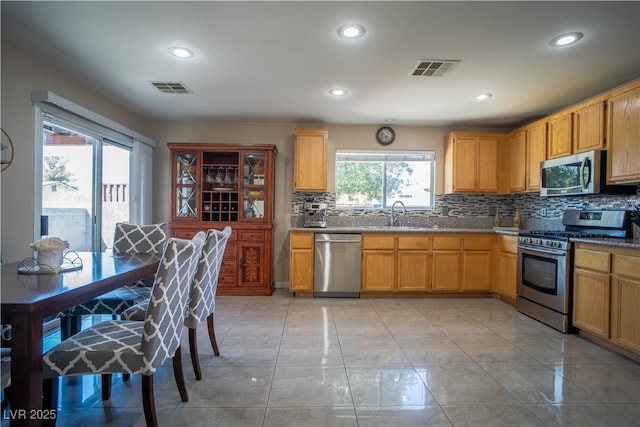 4945 Volcanic Rock Ln, Las Vegas, NV 89122 - kitchen with appliances with stainless steel finishes, decorative backsplash, and recessed lighting