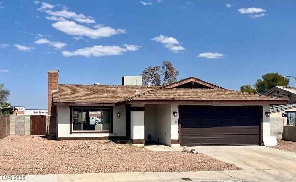 4276 Aspen St, Las Vegas, NV 89147 - single story home featuring a garage, stucco siding, concrete driveway, and a chimney