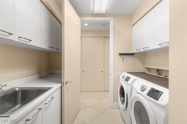 2747 Paradise Rd Unit 2704, Las Vegas, NV 89109 - laundry room with cabinet space, washer and dryer, and light tile patterned flooring