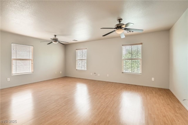 5021 Ropers Rock Ct, Las Vegas, NV 89131 - unfurnished room featuring a ceiling fan, plenty of natural light, light wood finished floors, and a textured ceiling