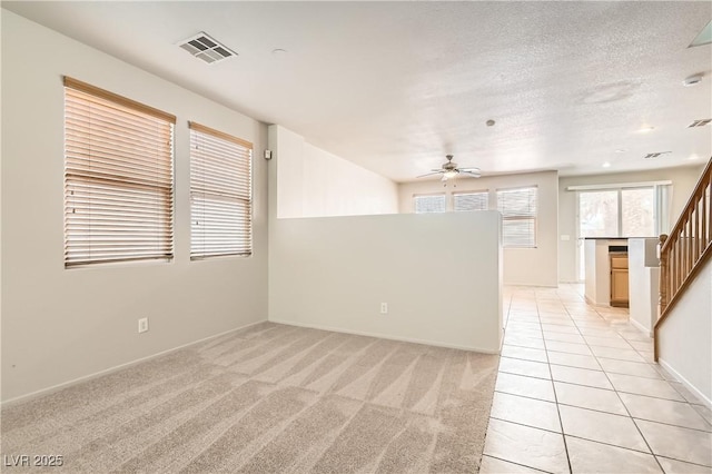 5021 Ropers Rock Ct, Las Vegas, NV 89131 - unfurnished living room featuring ceiling fan, stairway, light colored carpet, and light tile patterned floors