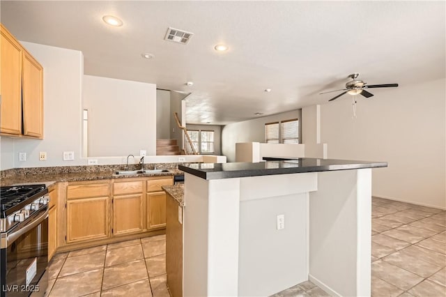 5021 Ropers Rock Ct, Las Vegas, NV 89131 - kitchen featuring stainless steel gas range, a kitchen island, light tile patterned flooring, dark countertops, and recessed lighting