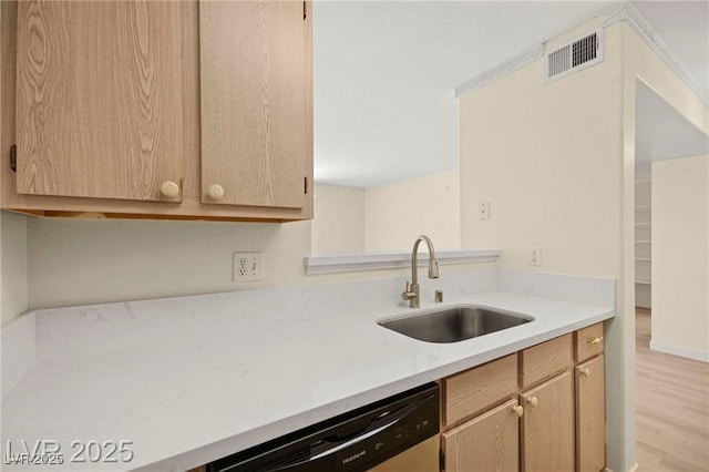 7885 W Flamingo Rd Unit 1131, Las Vegas, NV 89147 - kitchen with dishwashing machine, light countertops, light brown cabinetry, and light wood-style flooring
