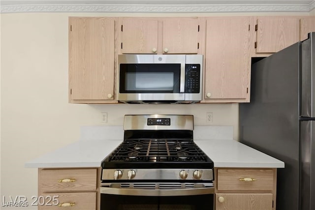 7885 W Flamingo Rd Unit 1131, Las Vegas, NV 89147 - kitchen with stainless steel appliances, light brown cabinetry, and light countertops