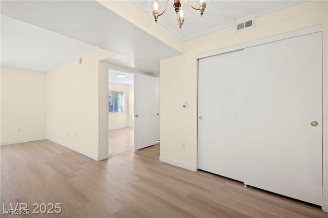 7885 W Flamingo Rd Unit 1131, Las Vegas, NV 89147 - unfurnished room featuring a chandelier, wood finished floors, and crown molding