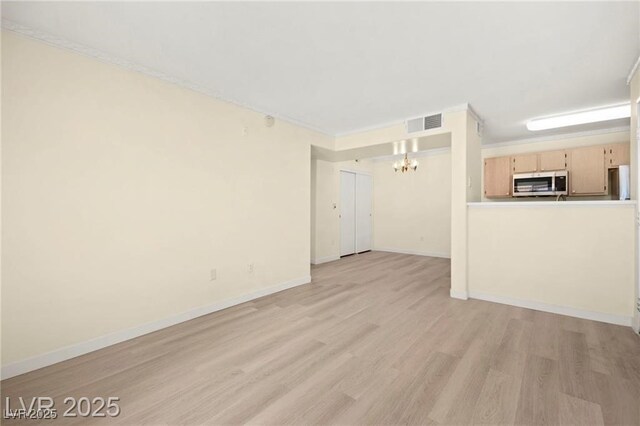 7885 W Flamingo Rd Unit 1131, Las Vegas, NV 89147 - unfurnished living room with a chandelier and light wood-style flooring