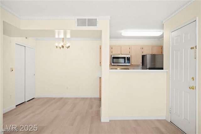 7885 W Flamingo Rd Unit 1131, Las Vegas, NV 89147 - kitchen featuring appliances with stainless steel finishes, light wood-style floors, a chandelier, light brown cabinetry, and crown molding