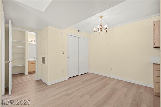 7885 W Flamingo Rd Unit 1131, Las Vegas, NV 89147 - unfurnished dining area featuring light wood finished floors and a chandelier