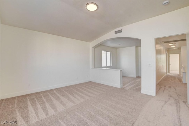 1716 Klamath Falls Way, Las Vegas, NV 89128 - empty room with light colored carpet, a smoke detector, arched walkways, and vaulted ceiling