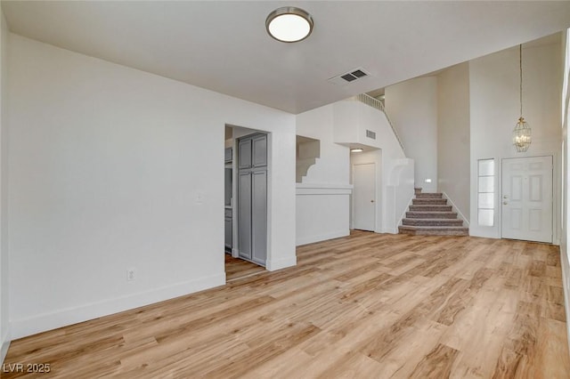 1716 Klamath Falls Way, Las Vegas, NV 89128 - unfurnished living room featuring stairway and light wood-style flooring