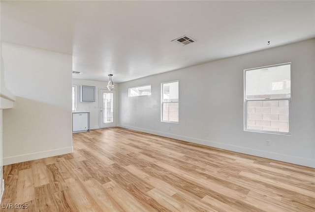 1716 Klamath Falls Way, Las Vegas, NV 89128 - unfurnished living room featuring light wood-type flooring and a chandelier