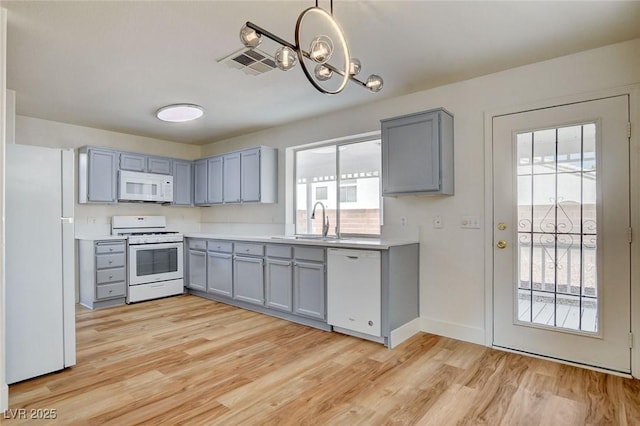1716 Klamath Falls Way, Las Vegas, NV 89128 - kitchen featuring white appliances, gray cabinetry, and healthy amount of natural light