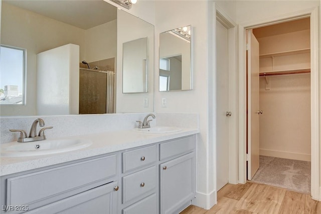 1716 Klamath Falls Way, Las Vegas, NV 89128 - full bathroom with a shower stall, a walk in closet, double vanity, and wood finished floors