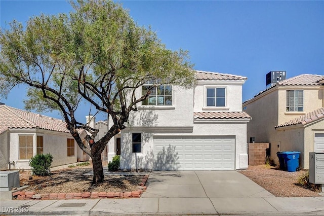 1716 Klamath Falls Way, Las Vegas, NV 89128 - mediterranean / spanish home featuring a tile roof, concrete driveway, an attached garage, and stucco siding