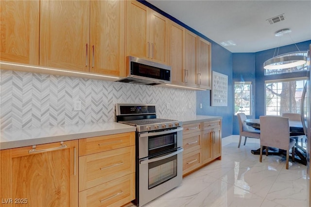 1910 Coyote Pass Way, Henderson, NV 89012 - kitchen with stainless steel appliances, light brown cabinetry, light countertops, and tasteful backsplash