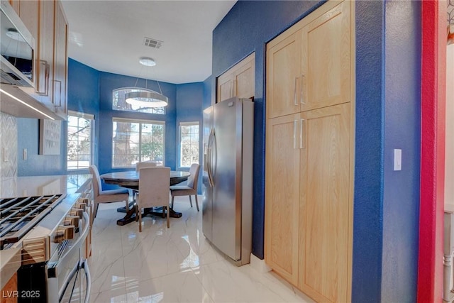 1910 Coyote Pass Way, Henderson, NV 89012 - kitchen with appliances with stainless steel finishes, light brown cabinets, and light marble finish floors