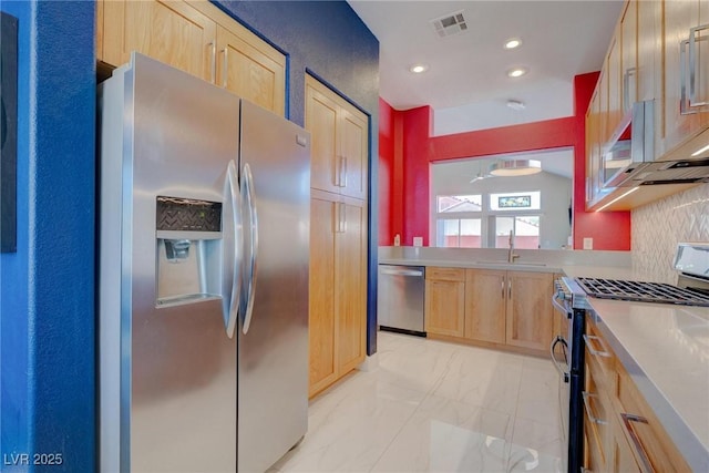 1910 Coyote Pass Way, Henderson, NV 89012 - kitchen featuring appliances with stainless steel finishes, light brown cabinets, light marble finish flooring, recessed lighting, and light countertops