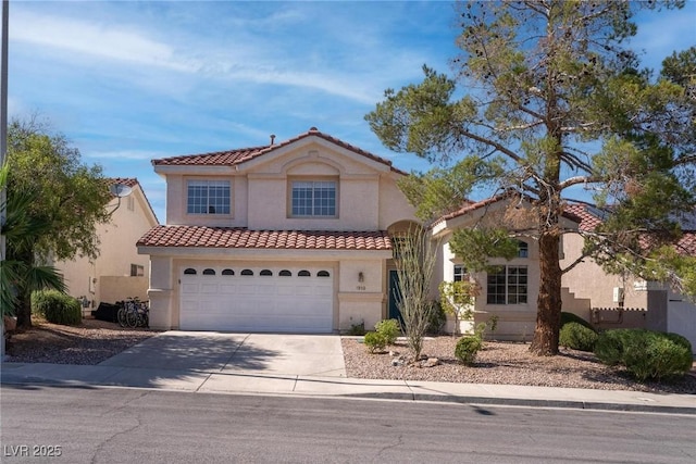 1910 Coyote Pass Way, Henderson, NV 89012 - mediterranean / spanish-style home featuring a tiled roof, stucco siding, driveway, and a garage