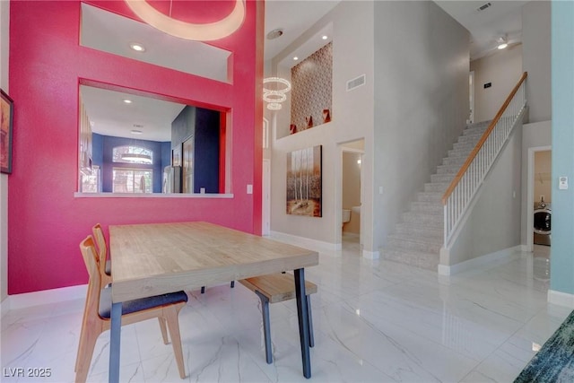 1910 Coyote Pass Way, Henderson, NV 89012 - dining space featuring marble tiled floors, stairs, a towering ceiling, and recessed lighting
