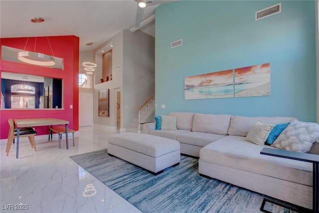 1910 Coyote Pass Way, Henderson, NV 89012 - living area with marble finish flooring, high vaulted ceiling, stairs, and ceiling fan