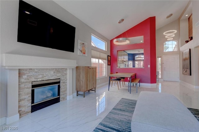 1910 Coyote Pass Way, Henderson, NV 89012 - living area featuring high vaulted ceiling, marble tiled floors, and a stone fireplace