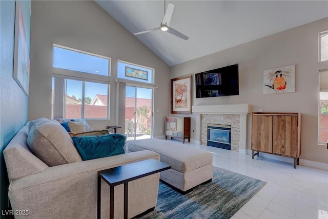 1910 Coyote Pass Way, Henderson, NV 89012 - living room with high vaulted ceiling, ceiling fan, a stone fireplace, and marble look tile flooring