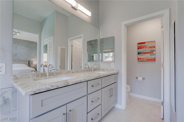 1910 Coyote Pass Way, Henderson, NV 89012 - bathroom featuring double vanity, ensuite bathroom, tile patterned flooring, and ceiling fan