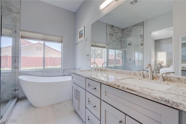 1910 Coyote Pass Way, Henderson, NV 89012 - bathroom with double vanity, a marble finish shower, a freestanding tub, and tile patterned floors