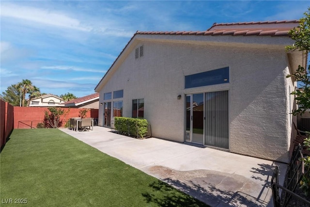 1910 Coyote Pass Way, Henderson, NV 89012 - back of house featuring stucco siding, a patio, a fenced backyard, and a tile roof