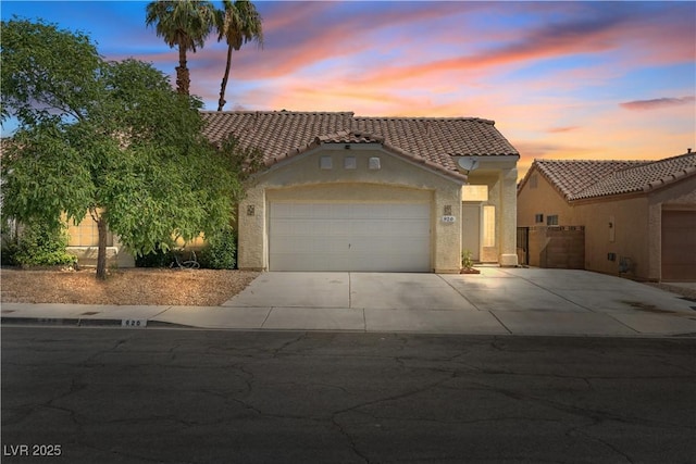920 Serpentina Ave, Las Vegas, NV 89123 - mediterranean / spanish-style house with concrete driveway, a tiled roof, a garage, and stucco siding