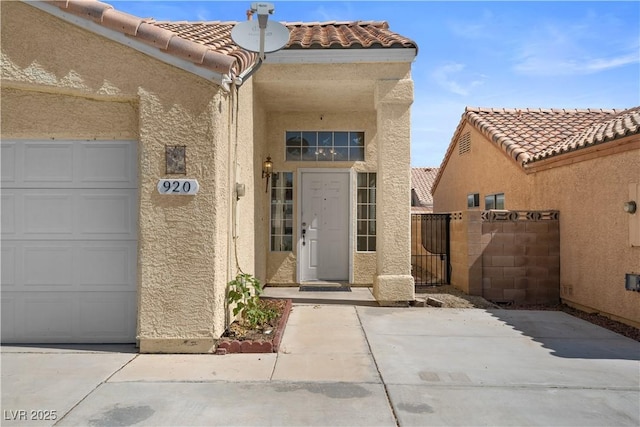 920 Serpentina Ave, Las Vegas, NV 89123 - property entrance with stucco siding, a tiled roof, a garage, and a gate