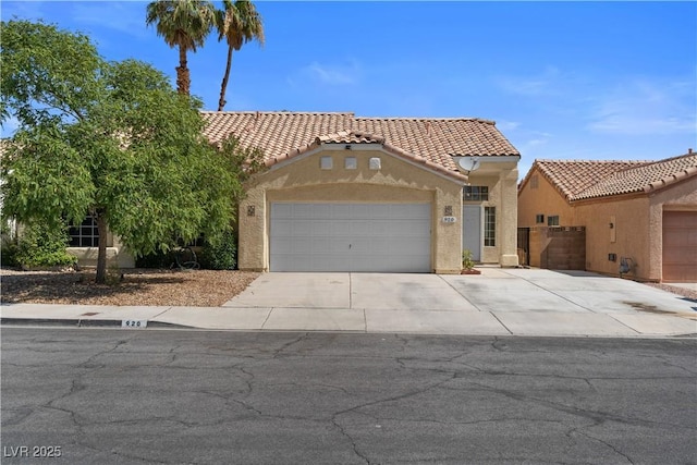 920 Serpentina Ave, Las Vegas, NV 89123 - mediterranean / spanish-style home featuring driveway, stucco siding, a garage, and a tile roof