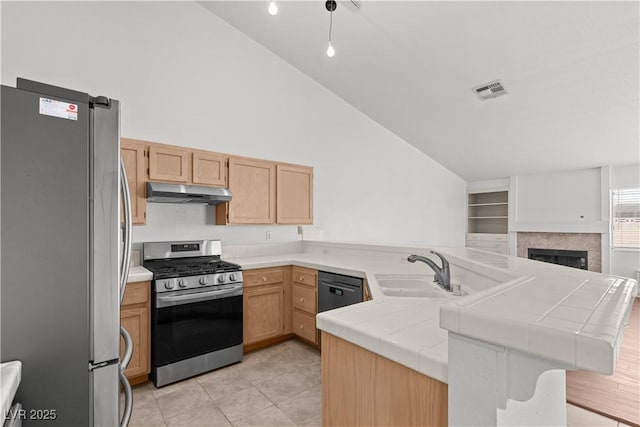 920 Serpentina Ave, Las Vegas, NV 89123 - kitchen featuring stainless steel appliances, under cabinet range hood, a peninsula, tile countertops, and light brown cabinets
