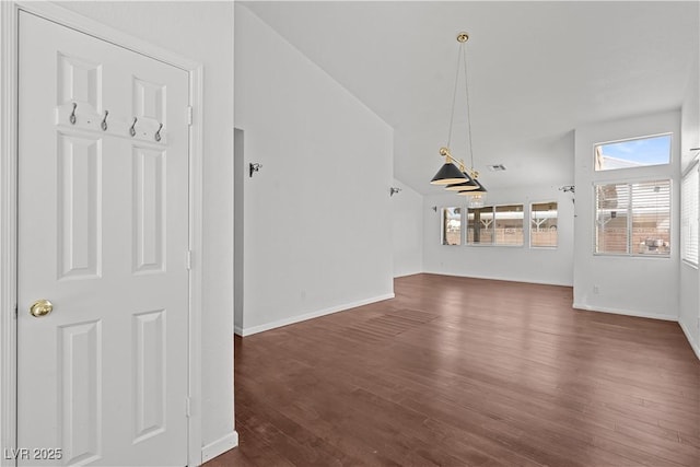 920 Serpentina Ave, Las Vegas, NV 89123 - unfurnished living room featuring dark wood-style floors and vaulted ceiling