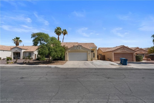 920 Serpentina Ave, Las Vegas, NV 89123 - mediterranean / spanish home featuring an attached garage, a tile roof, and stucco siding