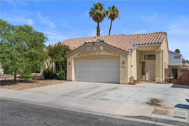 920 Serpentina Ave, Las Vegas, NV 89123 - mediterranean / spanish home with stucco siding, a tile roof, concrete driveway, and an attached garage