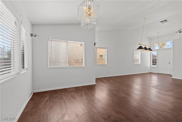 920 Serpentina Ave, Las Vegas, NV 89123 - unfurnished living room with a chandelier, wood finished floors, and plenty of natural light
